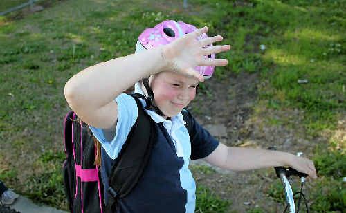 Teliah McGee fends off a magpie while riding home from school. Teliah McGee fends off a magpie while riding home from school.